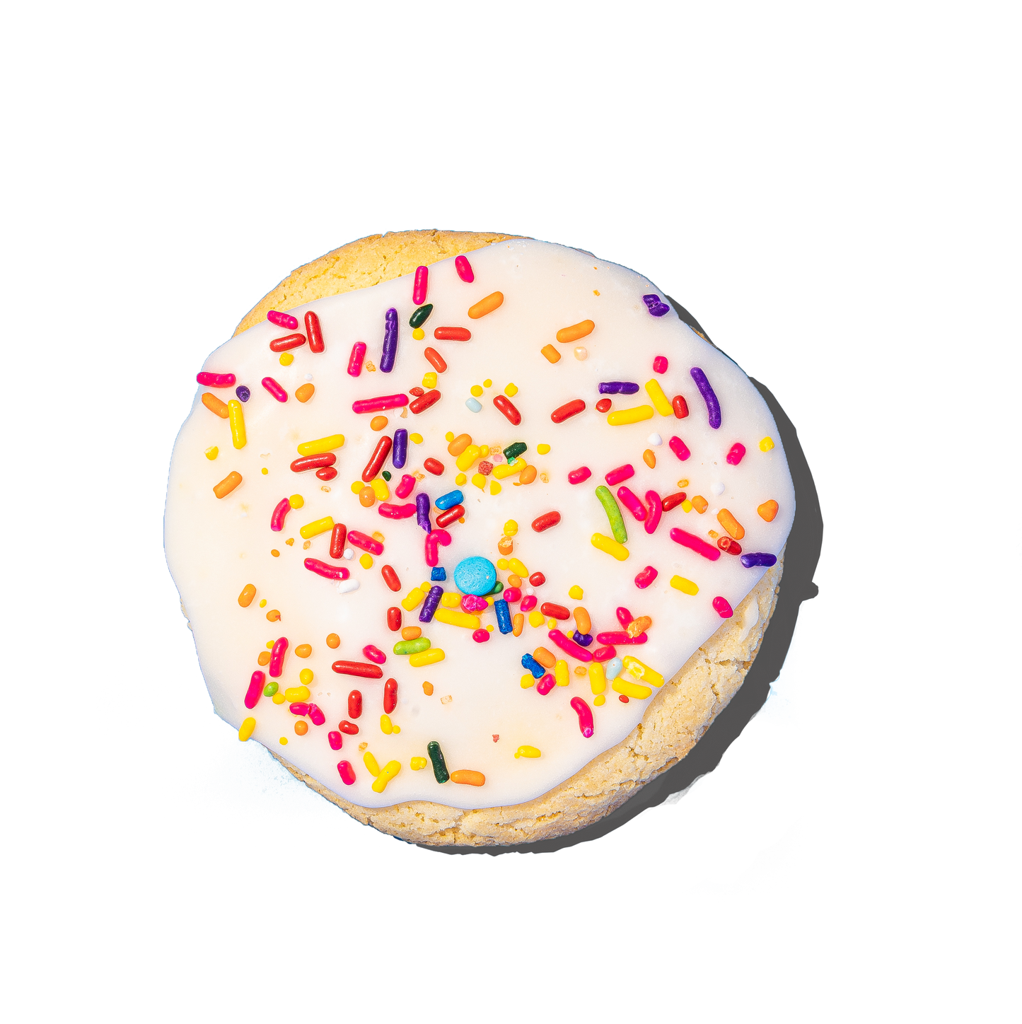 Cookie with white icing and colorful sprinkles on a white background