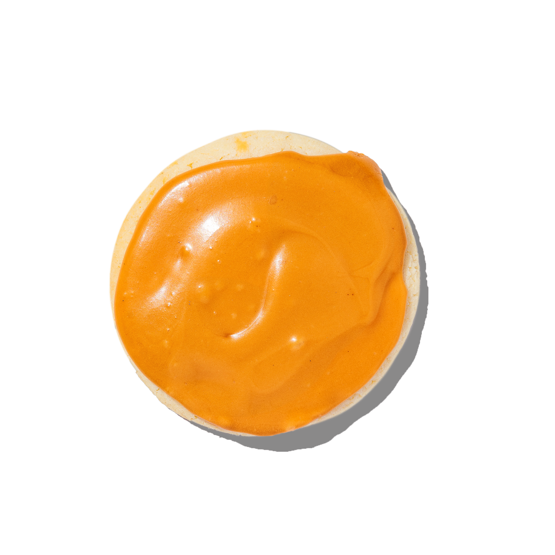 cookie with orange icing on a white background