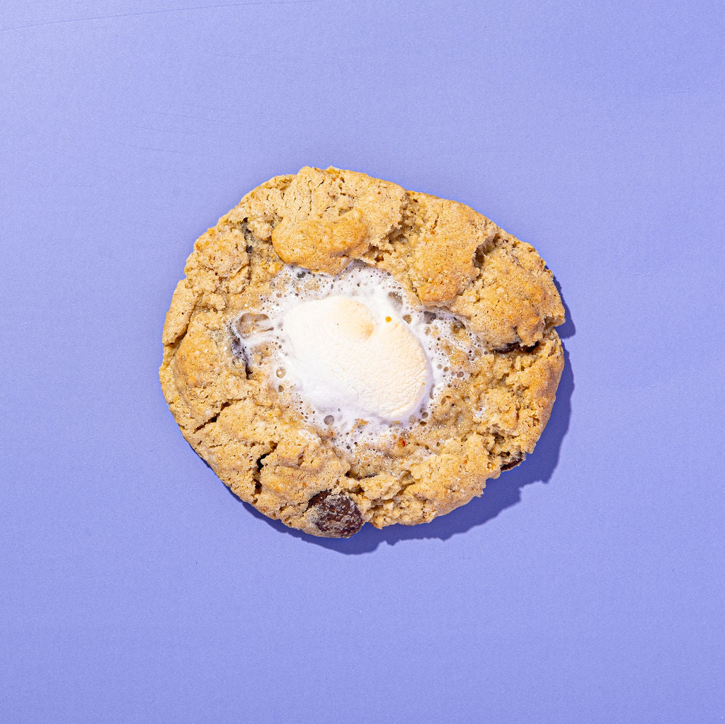 Cookie with a melted marshmallow on a purple background