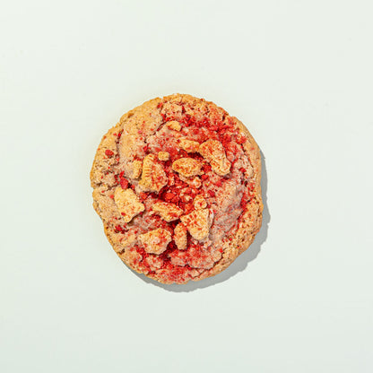 Cookie with visible strawberry pieces on a light background